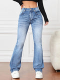 Model showcasing women’s slimming high waist bootcut jeans in Light Blue denim with white sneakers