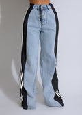 Light blue jeans with black and white stripe details on a plain background