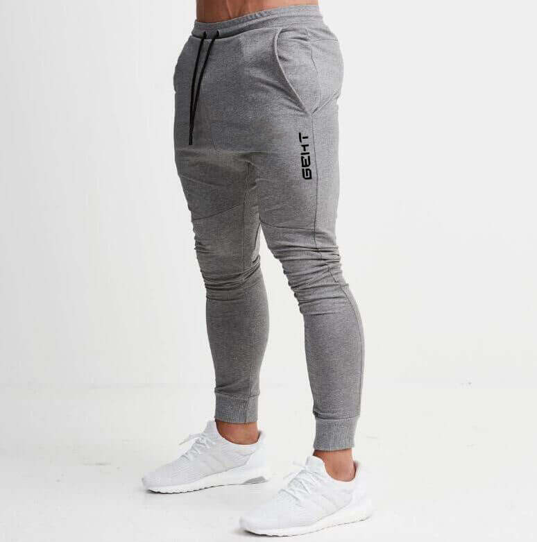Gray jogger pants with a brand logo on a white background