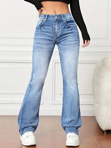 Model showcasing women’s slimming high waist bootcut jeans in blue denim with white sneakers
