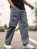Person wearing gray cargo pants on a street with a blurred background