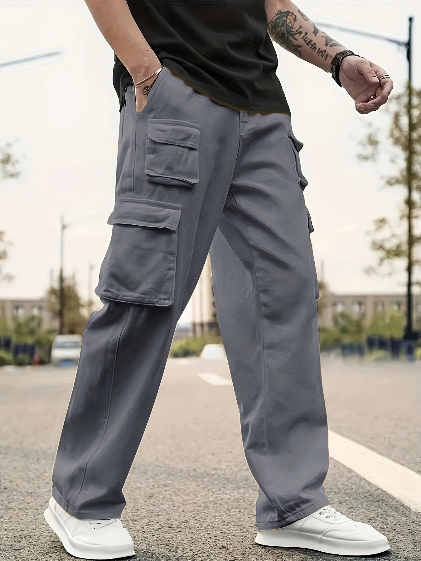 Person wearing gray cargo pants on a street with a blurred background