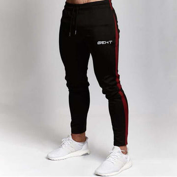 Black men’s gym jogger pants with red stripes and 'GENT' logo on white background