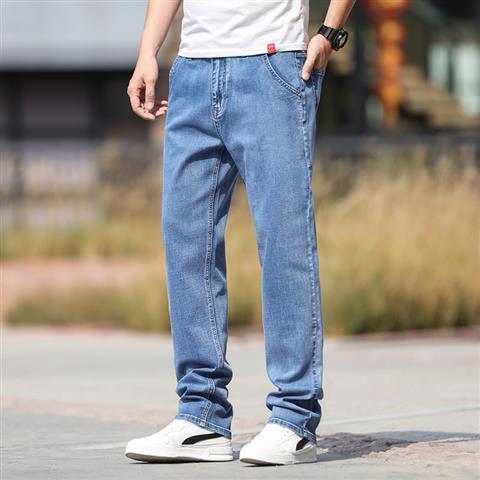 Person wearing blue jeans and a white shirt outdoors