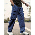 Person wearing blue cargo pants and white sneakers on a blurred street background