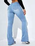 Light blue flared jeans worn by a person on a white background