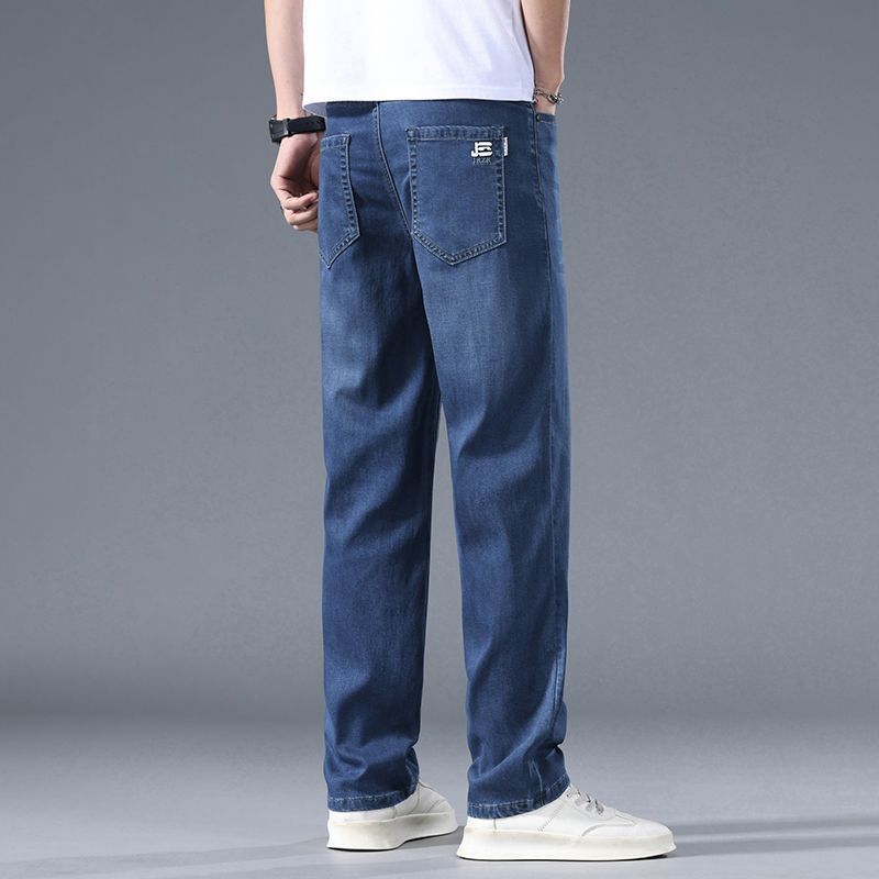 Person wearing blue jeans on a gray background