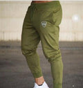Green Adidas jogger pants on a blurred background