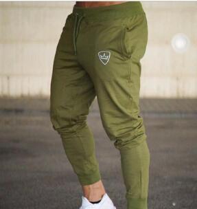 Green Adidas jogger pants on a blurred background