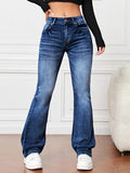 Model showcasing women’s slimming high waist bootcut jeans in blue denim with white sneakers