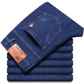 Stack of blue jeans with a brand label on a white background