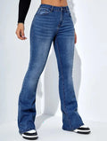 Woman wearing dark blue high-waist flared jeans in stretch denim on a white background, casual style