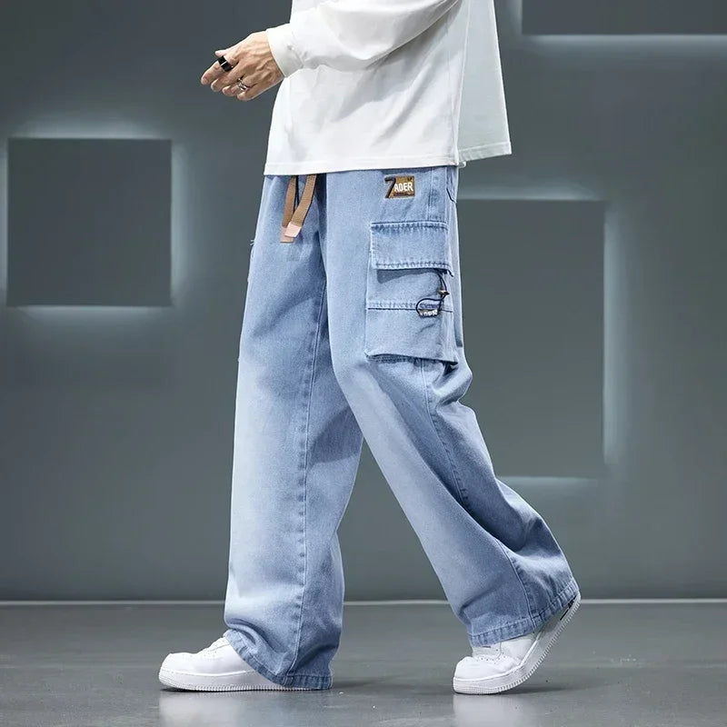 Men’s light blue cargo pants with wide-leg loose fit worn with white sneakers, streetwear style on a gray background