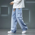 Men’s light blue cargo pants with wide-leg loose fit worn with white sneakers, streetwear style on a gray background