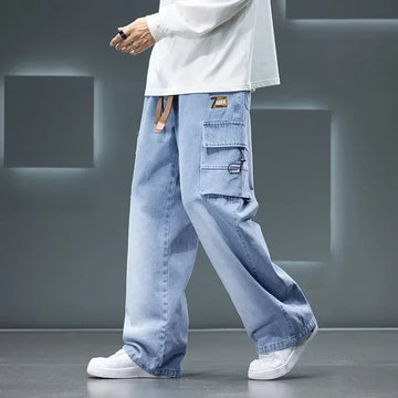 Men’s light blue cargo pants with wide-leg loose fit worn with white sneakers, streetwear style on a gray background