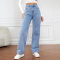 Woman wearing high-waisted retro baggy light blue jeans standing on a white background