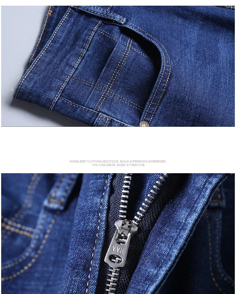 Close-up of blue denim fabric with stitching details and a zipper.