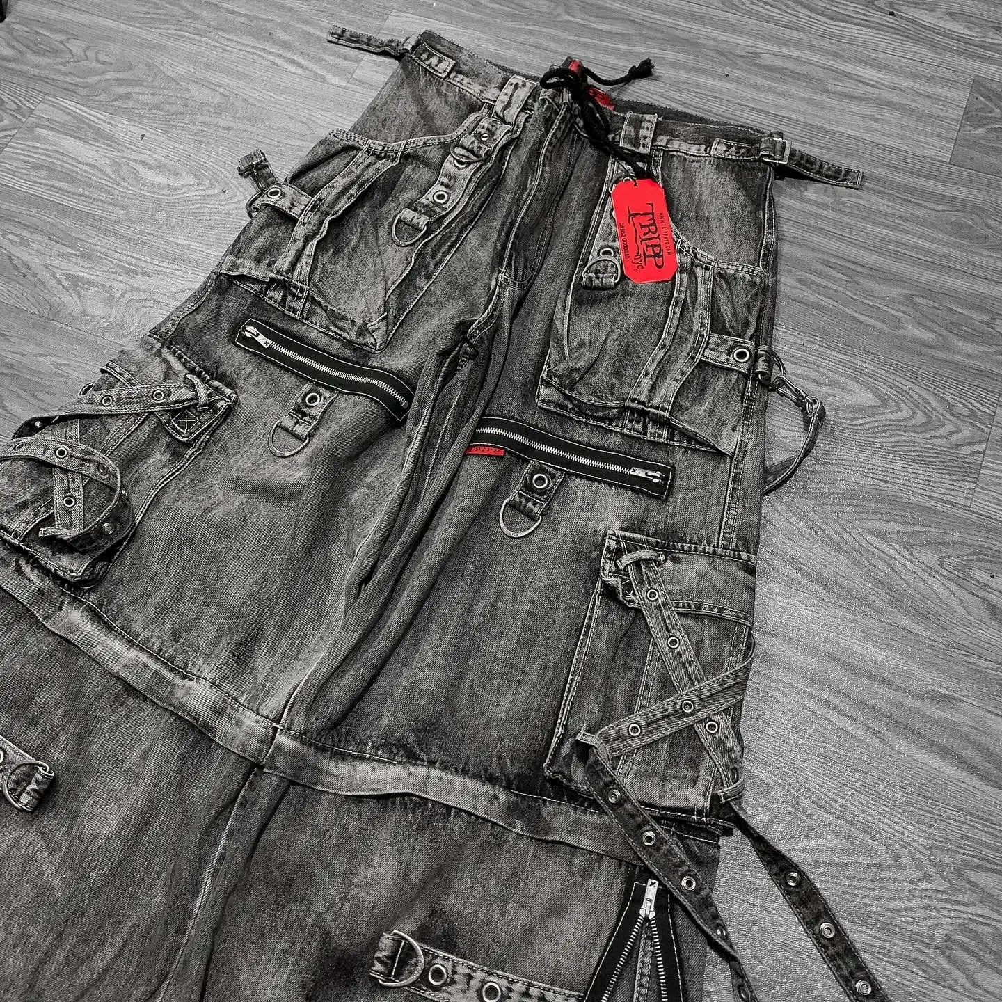 oversized hip hop wide-leg baggy denim jeans, shown from front view  with a red tag on a wooden floor