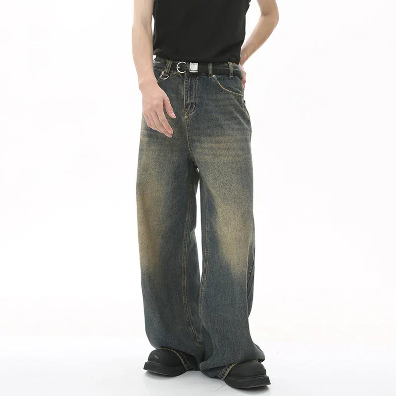 Man wearing men's wide-leg loose straight fit jeans on white background