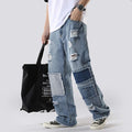 Man wearing casual baggy denim pants in loose street style on white background