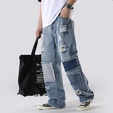 Man wearing casual baggy denim pants in loose street style on white background