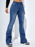 Blue flared jeans worn by a person on a white background
