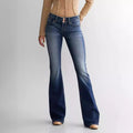 Women’s mid waist slim fit flared jeans in blue worn by a person on a plain background – JeansSpot”
