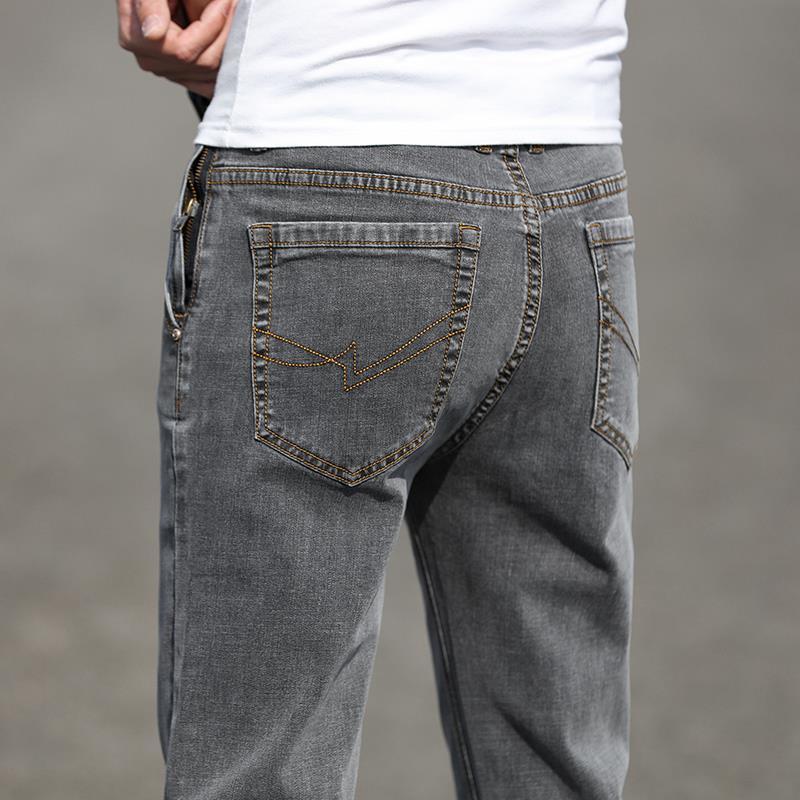 Gray jeans being worn with a blurred background
