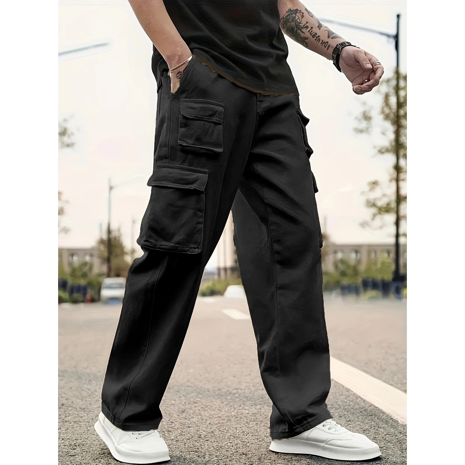 Person wearing black cargo pants with a blurred background