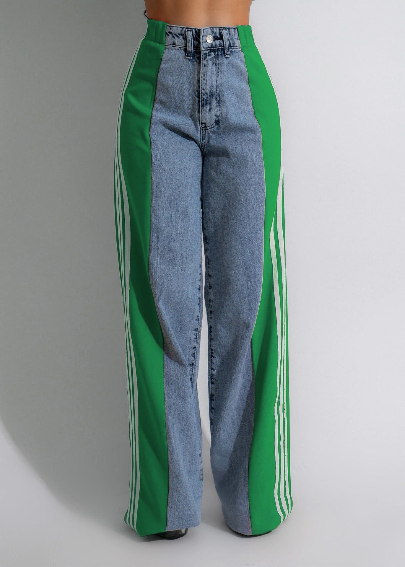 Blue jeans with green and white stripes on a gray background