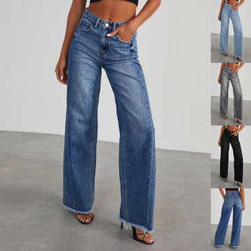 Model wearing blue high waist wide leg jeans with a straight leg design on a gray background.