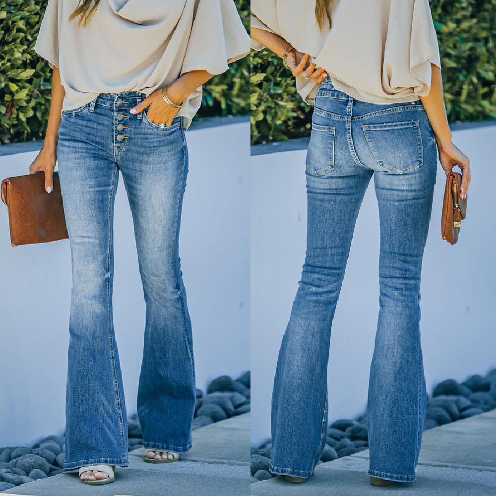 Person wearing blue high waisted bell bottom jeans with a neutral top and brown clutch against a white wall.