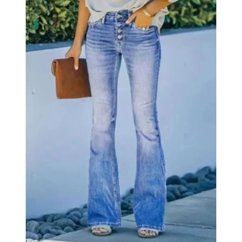 Person wearing style 7 blue high waisted bell bottom jeans with a blurred background.
